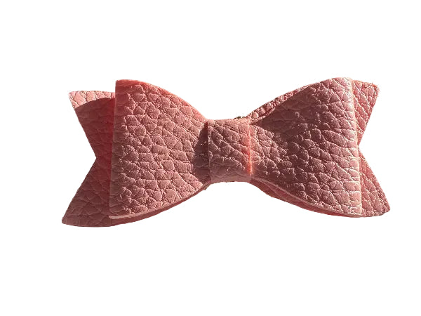 Pink textured bow on a white surface
