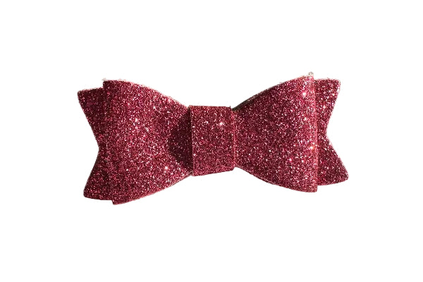 Pink glittery bow on a white surface